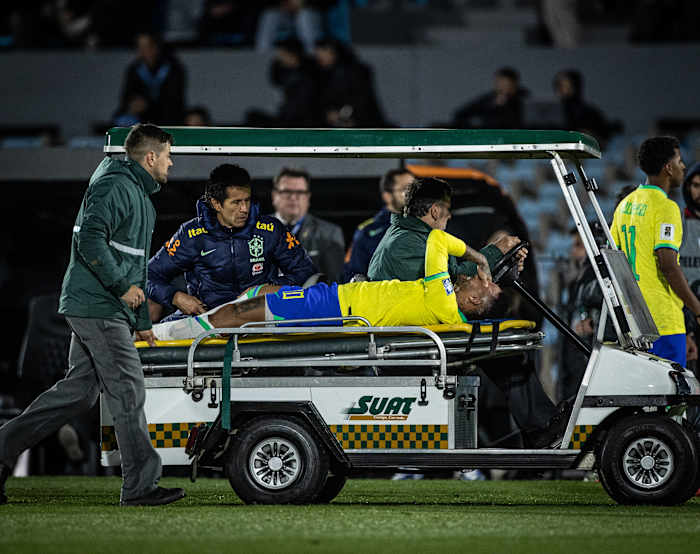 Brazil captain Neymar pictured crying as he leaves the pitch on a stretcher after suffering an injury to his left knee during a game against Uruguay in October 2023